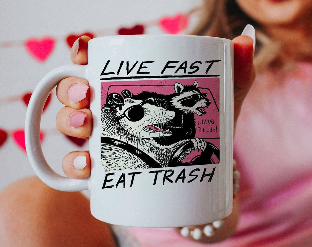 "Live Fast Eat Trash" design on a white ceramic coffee mug