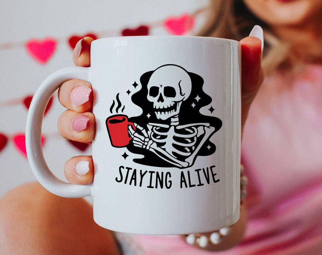 "Staying Alive Coffee" design on a white ceramic coffee mug