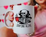 "Staying Alive Coffee" design on a white ceramic coffee mug