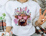 "Easter Highland Cow" design on an ash gray unisex crewneck sweatshirt