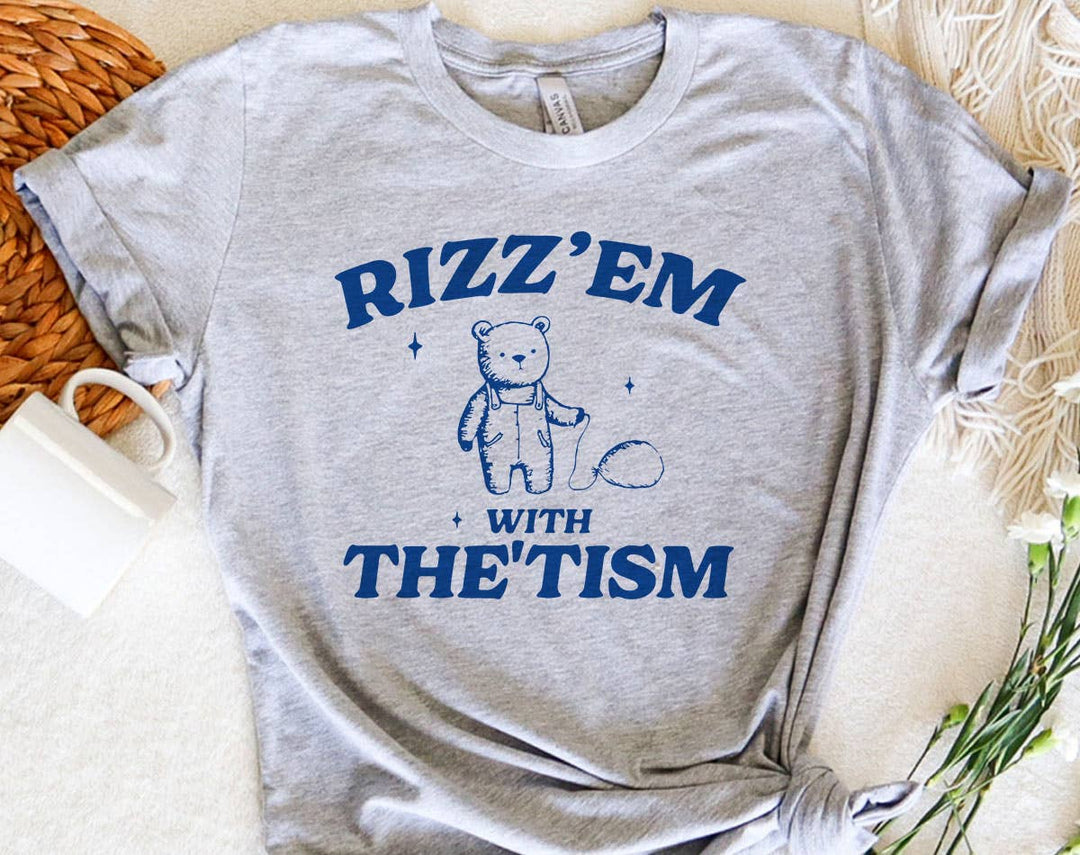 "Rizz 'Em With The 'Tism Bear" design on a heather gray unisex t-shirt