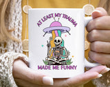 "At Least My Trauma Made Me Funny" design on a white ceramic coffee mug