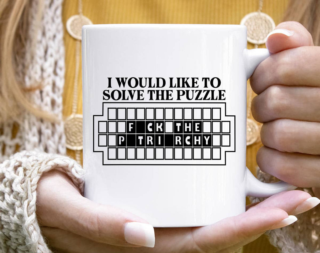 "Solve The Puzzle F*ck The Patriarchy" design on a white ceramic coffee mug