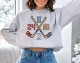 "Heated Rivalry Inspired 24 81 Hockey" design on an ash gray unisex crewneck sweatshirt