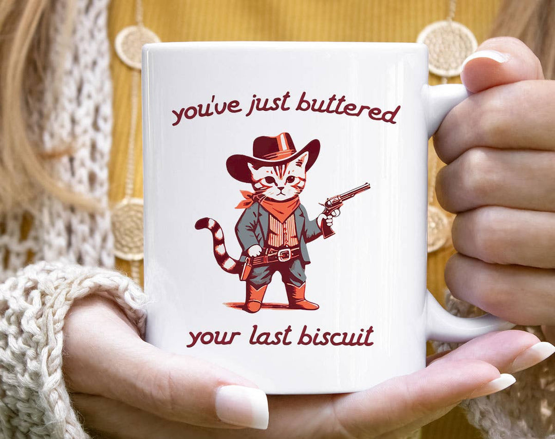 "You've Buttered Last Biscuit" design on a white ceramic coffee mug