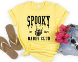 "Spooky Babes Club" design on a pale yellow unisex t-shirt