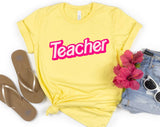 "Teacher Pink Logo" design on a pale yellow unisex t-shirt