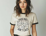 "Hoeing Ain't Easy" design on a natural ringer t-shirt with black contrast trim