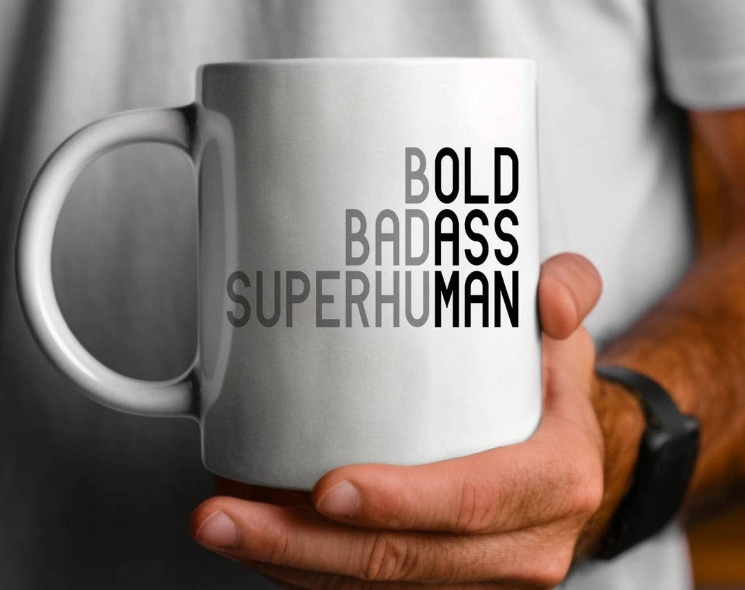 "Bold Badass Superhuman" design on a white ceramic coffee mug