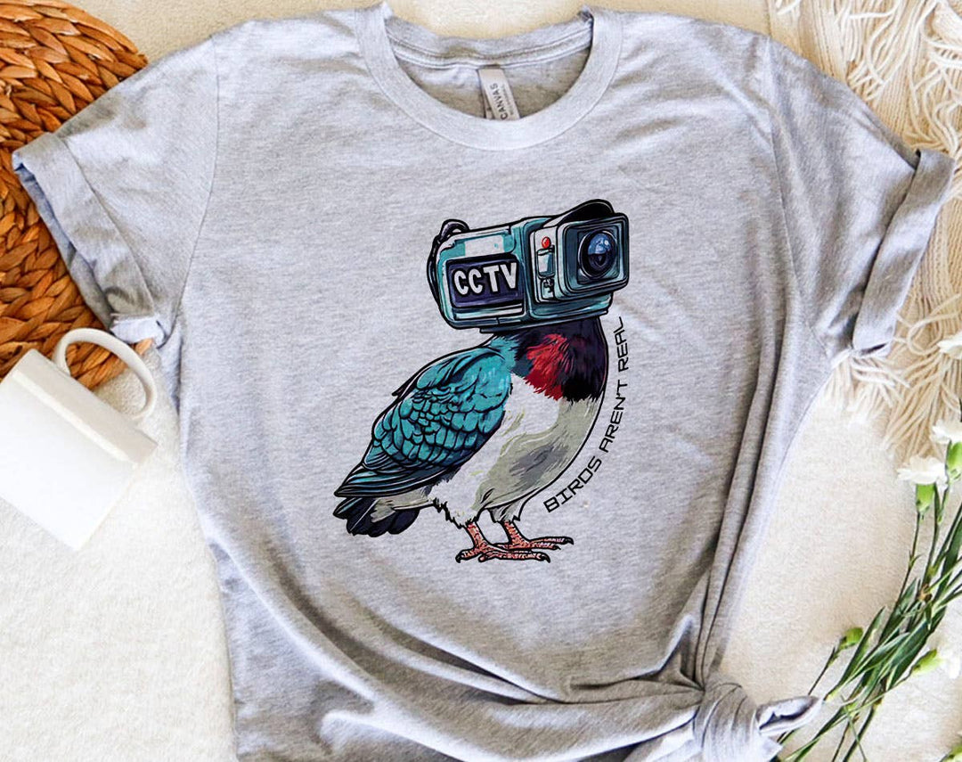 "Birds Aren't Real" design on a heather gray unisex t-shirt