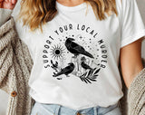 "Support Your Local Murder Crow" design on a white unisex t-shirt