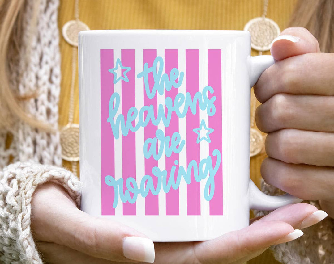 "The Heavens Are Roaring Faith Jesus" design on a white ceramic coffee mug