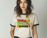 "Just Be A Good Human 2025" design on a natural ringer t-shirt with black contrast trim