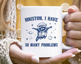 "Houston, I Have So Many Problems" design on a white ceramic coffee mug