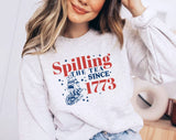 "Spilling The Tea Since 1773" design on an ash gray unisex crewneck sweatshirt
