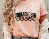 "Undiagnosed, But Something Ain't Right" design on a peach unisex t-shirt