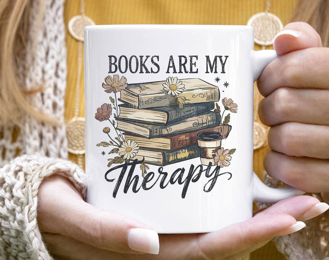 "Books Are My Therapy" design on a white ceramic coffee mug
