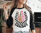 "Peace Out Cowboy" design on a white baseball raglan tee with black sleeves