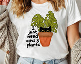 "I Just Need Cats And Plants" design on a white unisex t-shirt