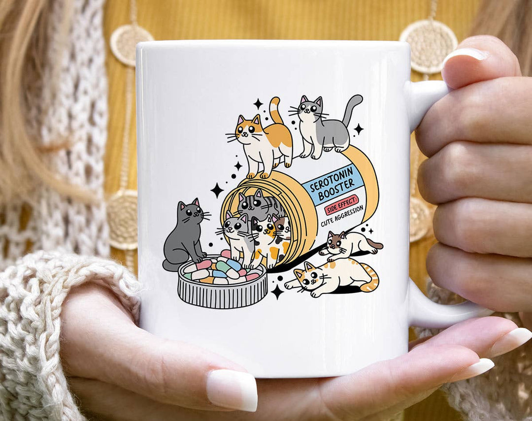 "Serotonin Booster Cats" design on a white ceramic coffee mug