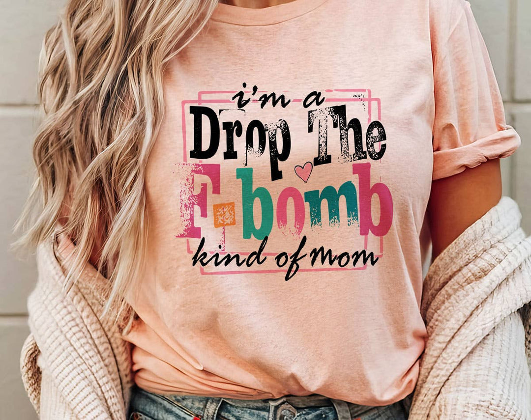 "I'm A Drop The F-Word Kind Of Mom" design on a peach unisex t-shirt