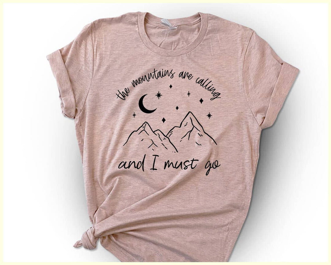 "The Mountains Are Calling" design on a peach unisex t-shirt