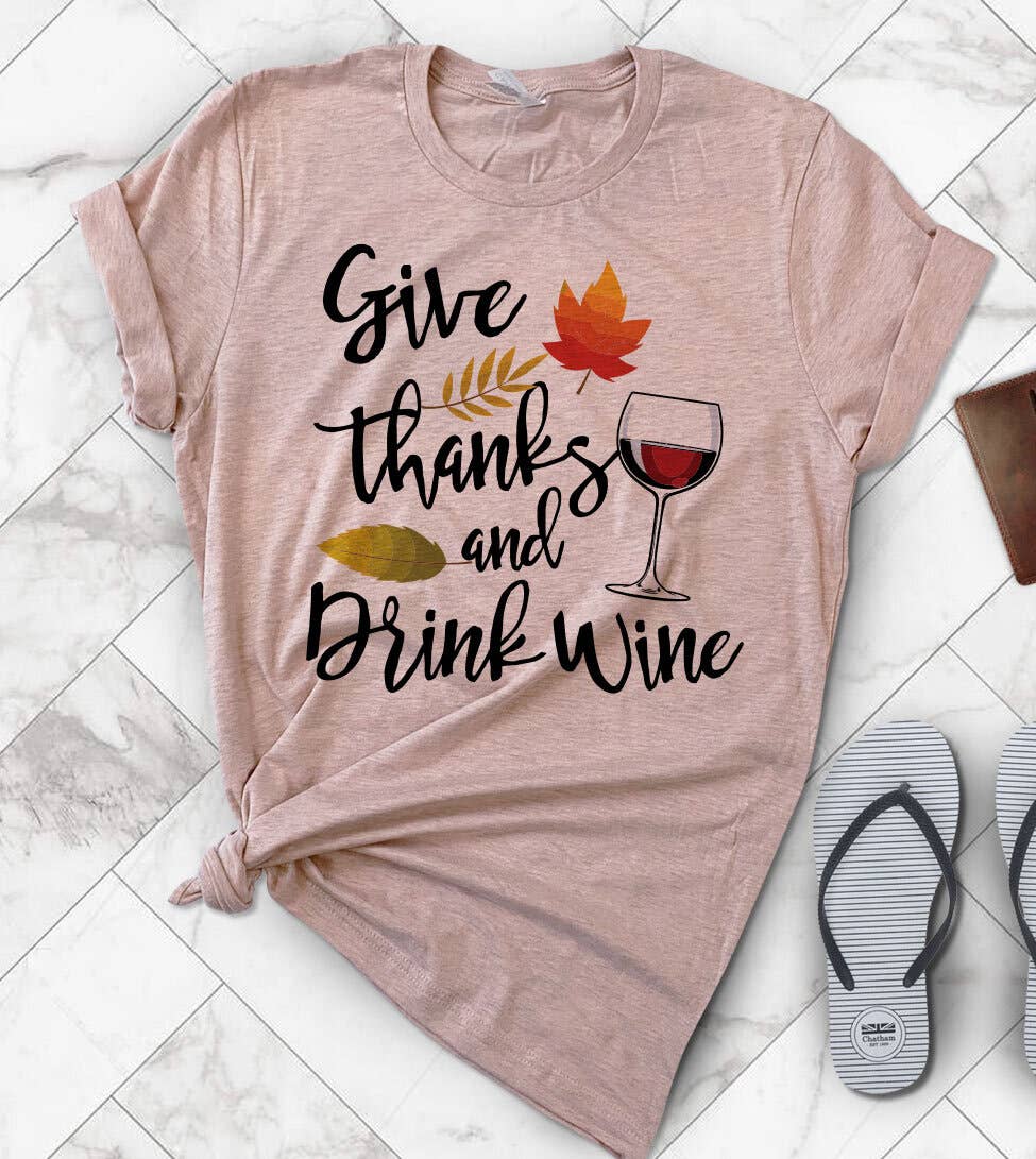 "Give Thanks And Drink Wine" design on a peach unisex t-shirt