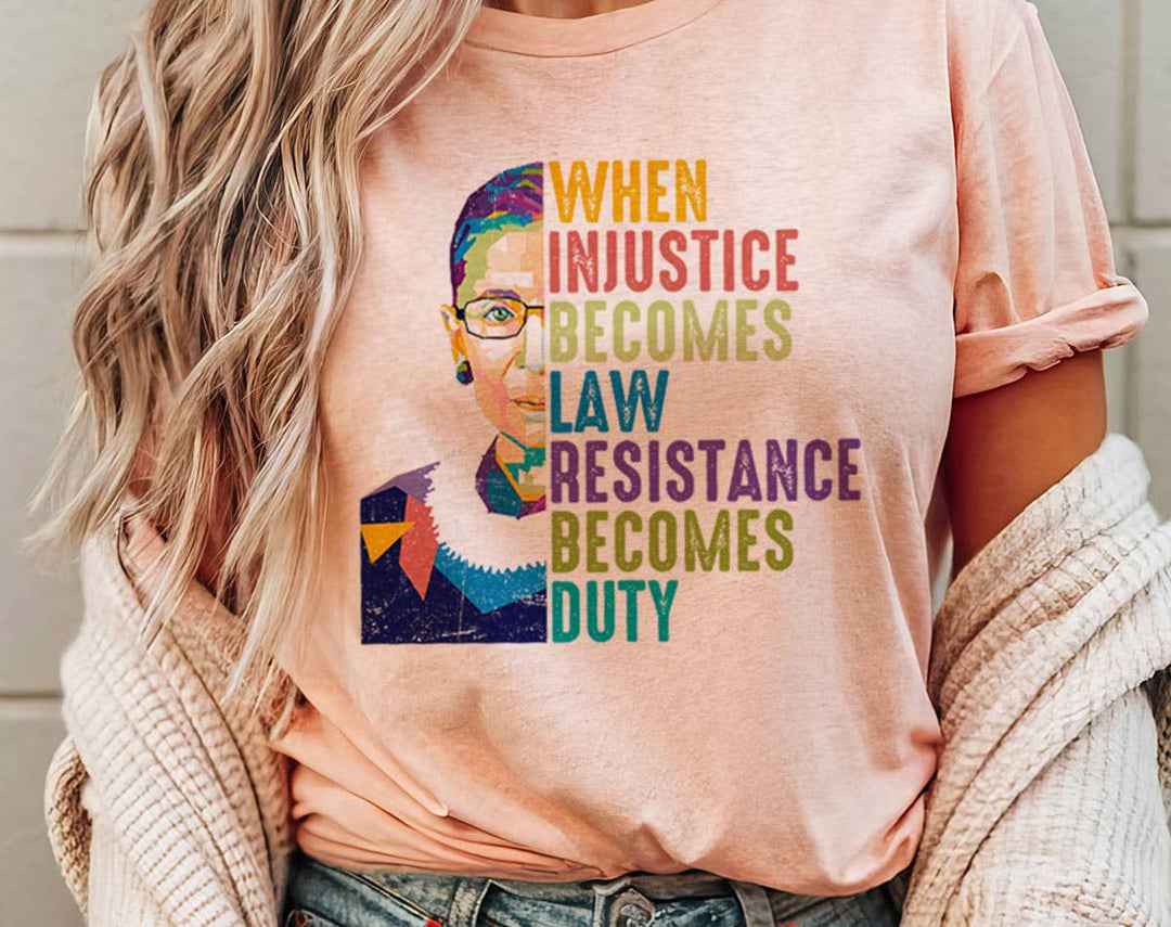 "When Injustice Becomes Law RBG" design on a peach unisex t-shirt