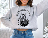 "One More Chapter Skeleton" design on an ash gray unisex crewneck sweatshirt