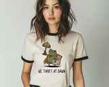 "We Thrift At Dawn Frog" design on a natural ringer t-shirt with black contrast trim
