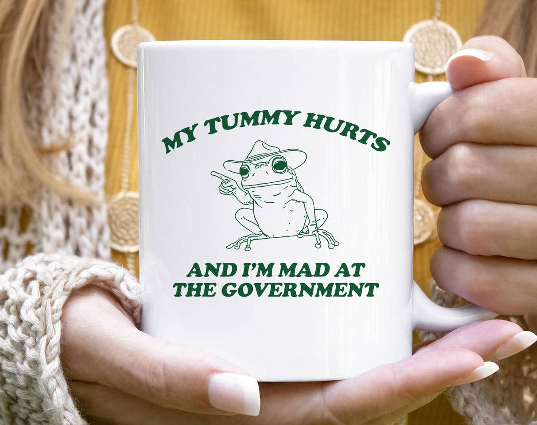 "My Tummy Hurts Frog" design on a white ceramic coffee mug