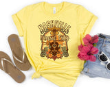 "Nashville Country Music City" design on a pale yellow unisex t-shirt