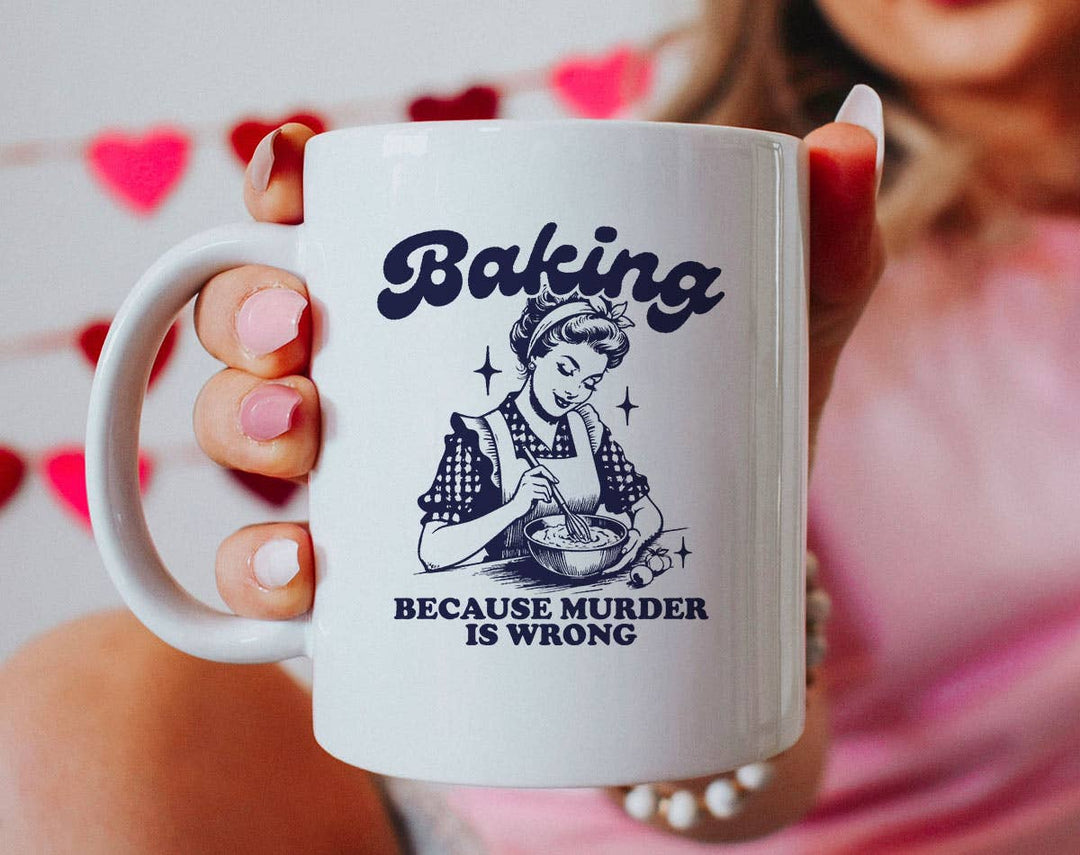 "Baking Because Murder Is Wrong" design on a white ceramic coffee mug